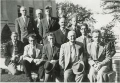 Twelve men on the steps of the courthouse
