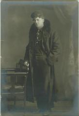 Unidentified young man wearing hat and fur coat