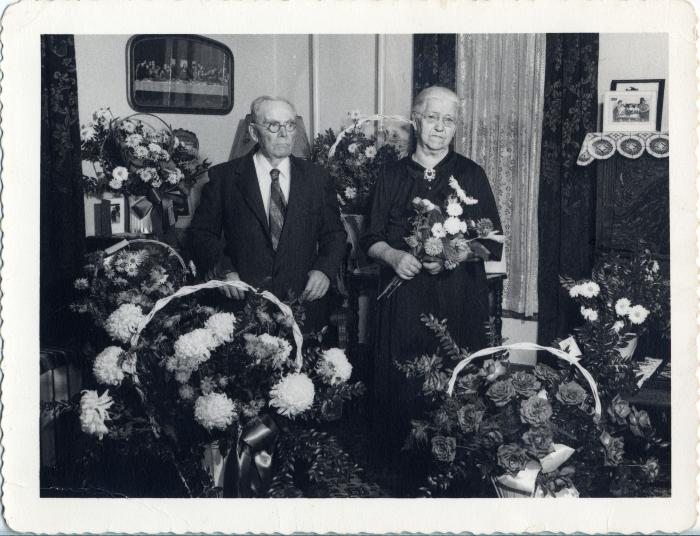 Mr. and Mrs. Magnuson surrounded with lots of flowers.
