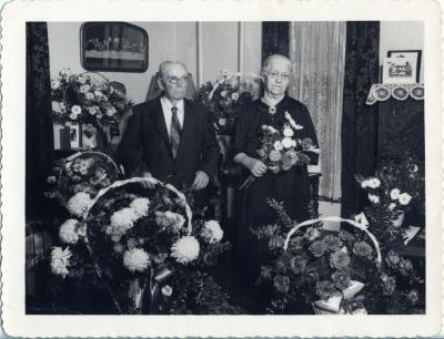 Mr. and Mrs. Magnuson surrounded with lots of flowers.