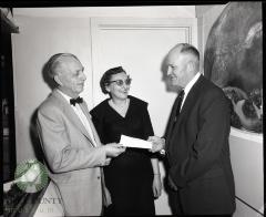 Mr. and Mrs. Ed. P. Kaldahl of Glenwood receive a check from Harry Anderson, Co-owner of the Glenwood Super Fair Store. Glenwood, Minnesota 