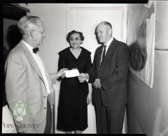 Mr. and Mrs. Ed. P. Kaldahl of Glenwood receive a check from Harry Anderson, Co-owner of the Glenwood Super Fair Store. Glenwood, Minnesota 