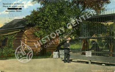Log Cabin and Bear Cage, Rochester, Minn.