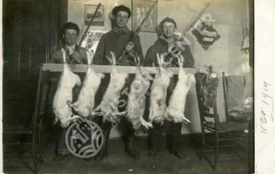 Hunters with rabbits