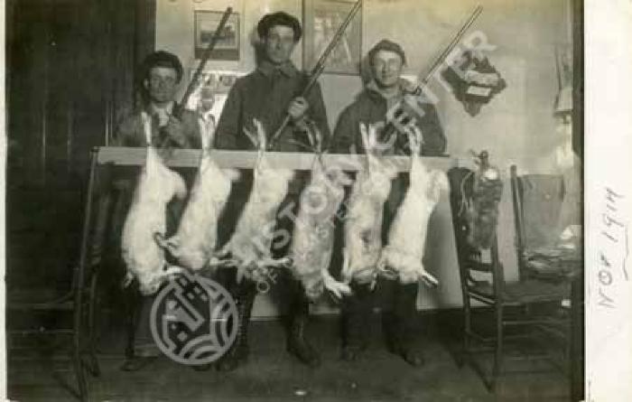 Hunters with rabbits