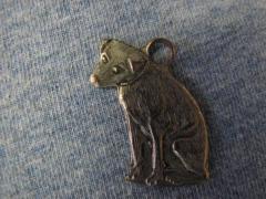 Dog-shaped metal charm from Glenwood Furniture Company