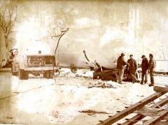 Local men removing liquid gas from rail car after derailment.