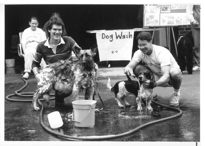 Christopher Holenstein and Joseph Sousa washing dogs