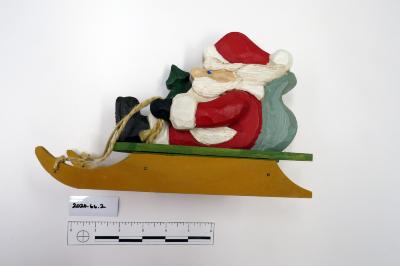 Santa on sled with tree and toy bear
