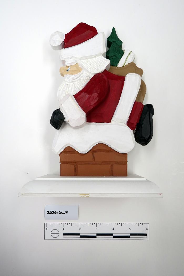 Santa entering a chimney with a bag of toys