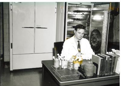 Man seated at a lab table, ca. 1960s