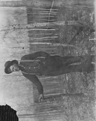 Carl Lidel standing with a rifle.