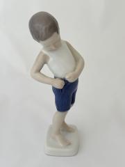 Sculpture - Boy buttoning short pants