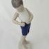 Sculpture - Boy buttoning short pants