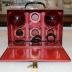 "FOR FIRE Shur-Stop Kit" With Red-Painted Tin Metal Carrying Case and Two (2) Red Glass Fire Hand Grenades;"FOR FIRE Shur-Stop Kit" With Red-Painted Tin Metal Carrying Case and Two (2) Red Glass Fire Hand Grenades
