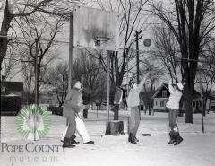 Young Children playing basketball in February in Glenwood, Minnesota