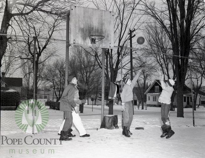 Young Children playing basketball in February in Glenwood, Minnesota