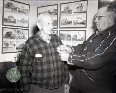 Roy Fisher gets a Pope County, Minnesota historical pin from B. O. Kleven. Glenwood, Minnesota