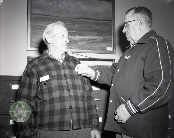 Roy Fisher gets a Pope County, Minnesota historical pin from B. O. Kleven. Glenwood, Minnesota