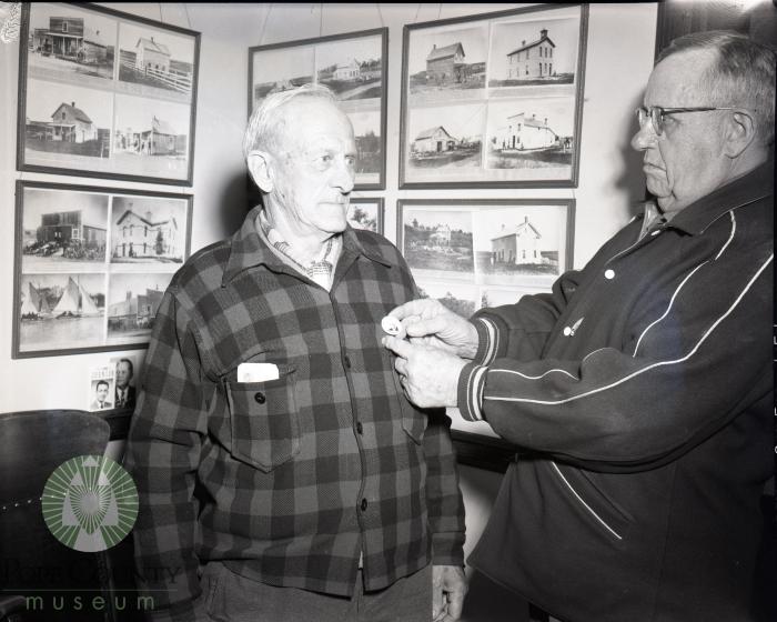 Roy Fisher gets a Pope County, Minnesota historical pin from B. O. Kleven. Glenwood, Minnesota