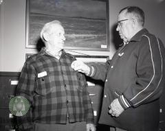 Roy Fisher gets a Pope County, Minnesota historical pin from B. O. Kleven. Glenwood, Minnesota