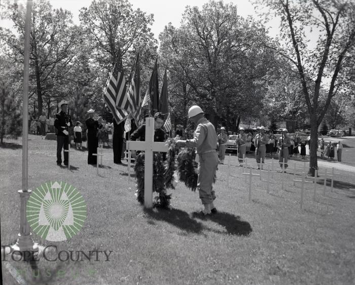 Officials decorate grave during the 1957 Memorial Day ceremonies. Glenwood, Minnesota