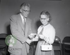 Mrs. Orville Feigum wins dairy heifer, Harold Kavale make the officla presentation. Glenwood, Minnesota