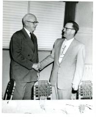 Herman Bolmgren and Pete Williams shaking hands , April 4, 1954