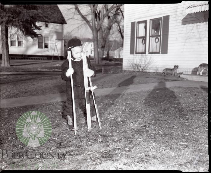 Billy Lee receives new skis for Christmas, Glenwood, Minnesota