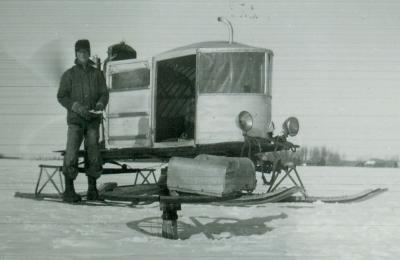 mailman standing out side his home-made air-snowmobile