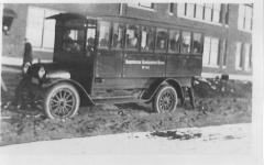 Bloomington Consolidated school bus outside the school circa 1918.