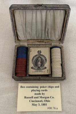 Cardboard box holding poker chips and deck of cards