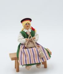 Doll Knitting on Bench: Doll