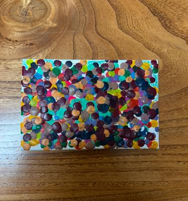 Paint-splattered artist's canvas board