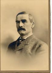 Black and white, sepia toned photograph of James Marshall