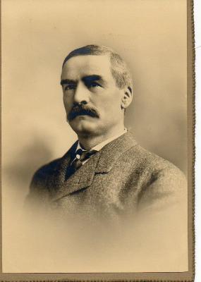 Black and white, sepia toned photograph of James Marshall