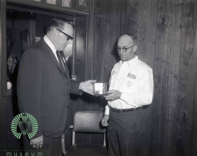 Bill Bodeker Receiving A Golden Watch from Harvey Gloege 