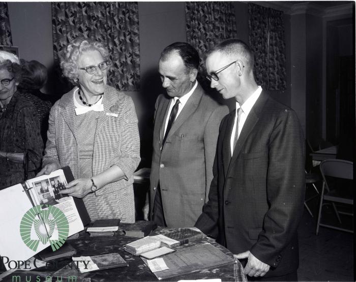 Olivia Peterson Showing Gordon Moe And Allen Nygaard Artifacts and Pictures of the Church