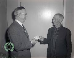 Reuben Eide Getting A $100 Dollar Check From Ole Barsness 