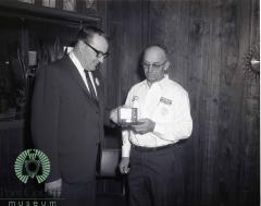  Harvey Gloege Presenting An Oldsmobile Goldwatch to Bill Bodeker a 10 Year Oldsmobile Serviceman