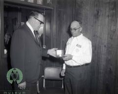 Bill Bodeker Receiving A Golden Watch from Harvey Gloege 