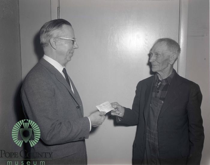 Reuben Eide Getting A $100 Dollar Check From Ole Barsness 