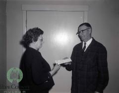 L. F. Gasser Giving a 550 dollar check to Mabel Barsness.