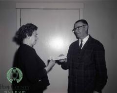 Mabel Barsness receiving $550 dollar donation from L. F. Gasser