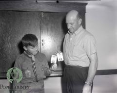 Unidentified Man and Boy from troop 423 holding two badges.