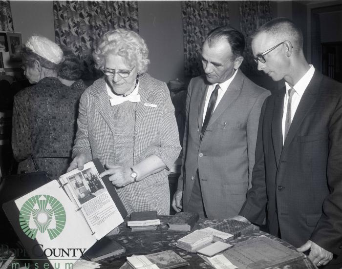 Olivia Peterson showing a display of artifacts and photo's of Indherred Lutheran Church