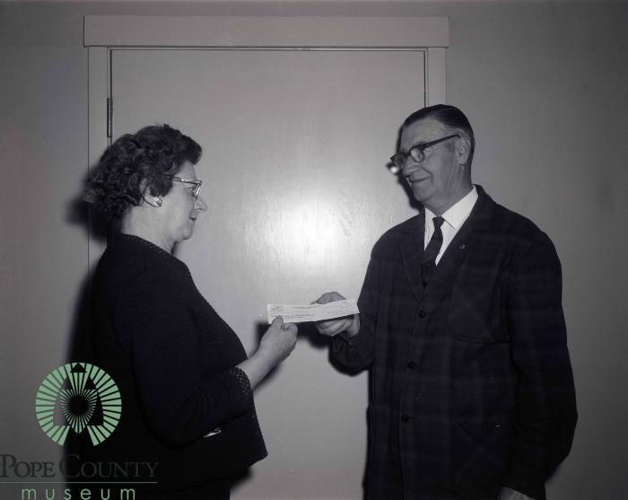 Mabel Barsness receiving $550 dollar donation from L. F. Gasser