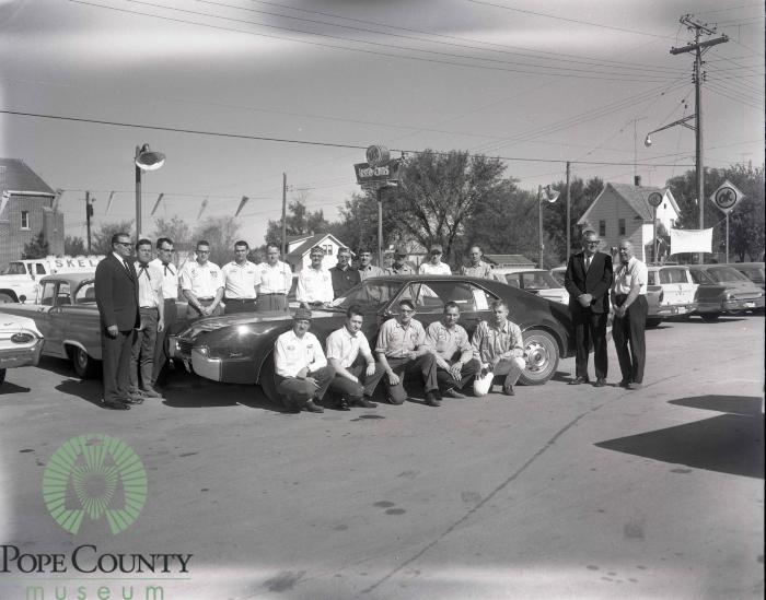 Members of the Gloege Chevrolet staff with Harvey and Dennis Gloege at the Gloege Chevrolet 20th anniversary  