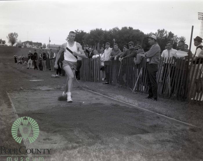 Unidentified Student Athlete competes in long jump