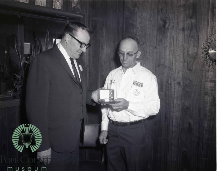  Harvey Gloege Presenting An Oldsmobile Goldwatch to Bill Bodeker a 10 Year Oldsmobile Serviceman